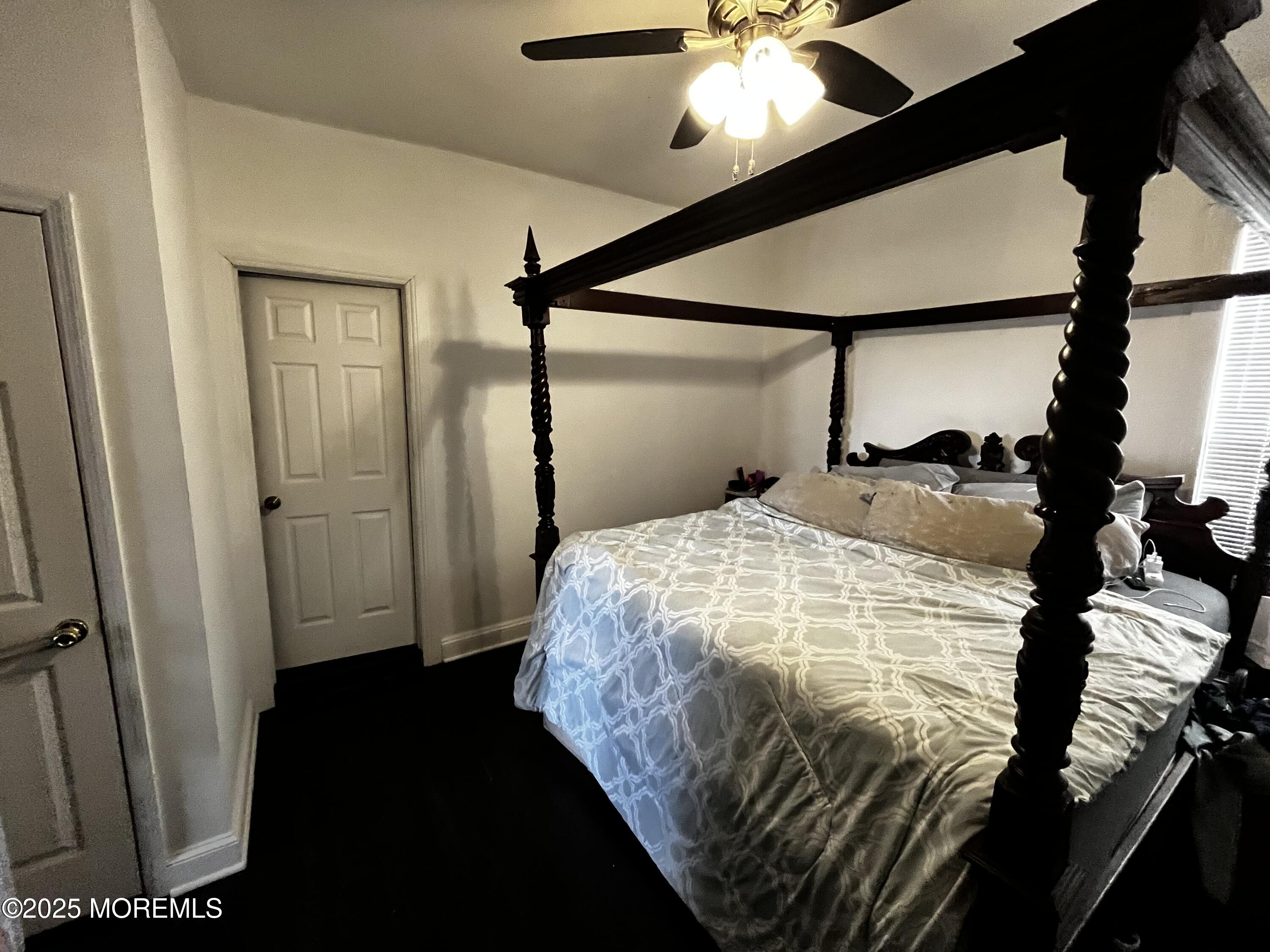 15 Rector Place, Unit A Red Bank, NJ 07701 - Photo 4 of 4 a bedroom with a bed and a chandelier