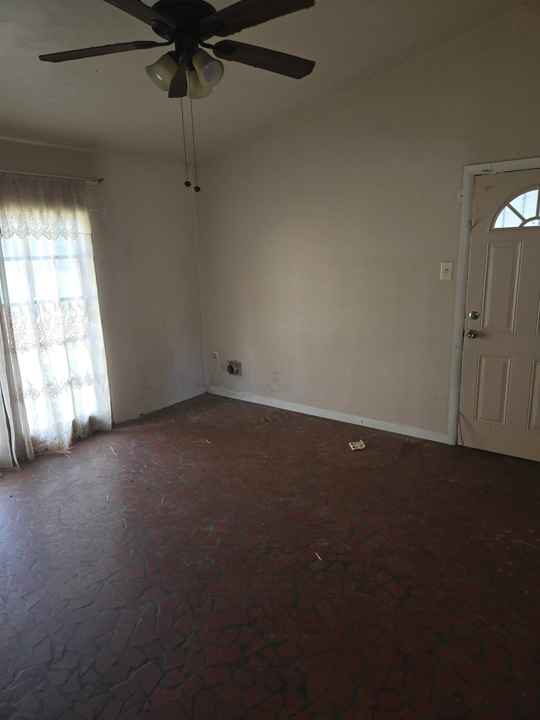 4898 Knight Arnold Road Memphis, TN 38118 - Photo 5 of 10 an empty room with a window and a fan
