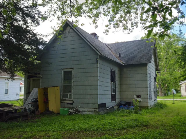 a front view of house with a garden