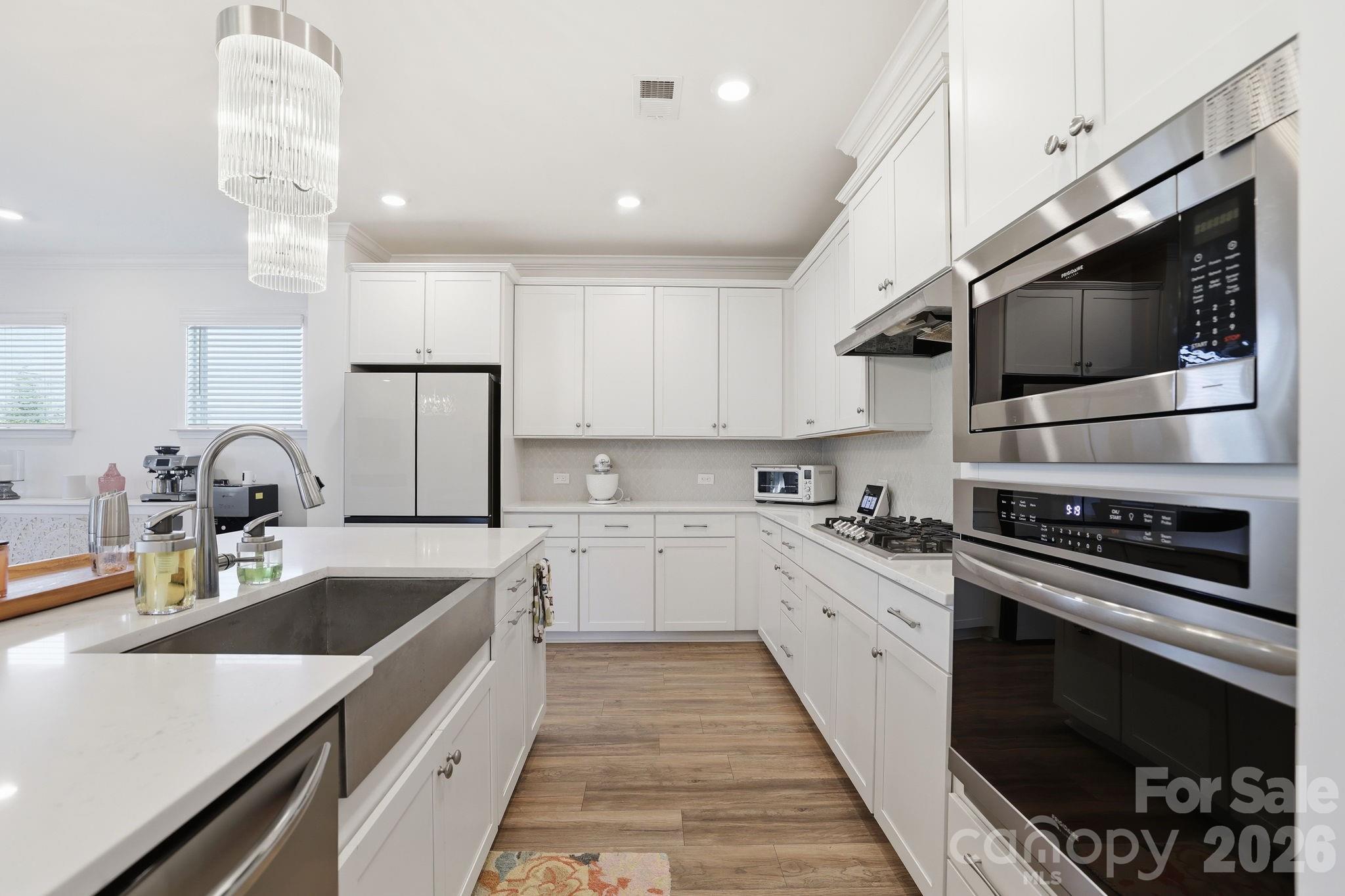 6038 Holland Street Fort Mill, SC 29707 - Photo 13 of 48 a kitchen with a sink stainless steel appliances and cabinets