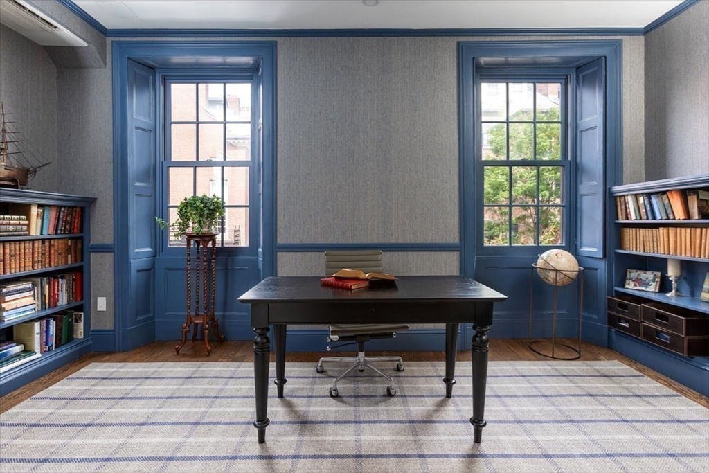 62 Chestnut Street Boston, MA 02108 - Photo 11 of 18 a view of a workspace with furniture and a bookshelf