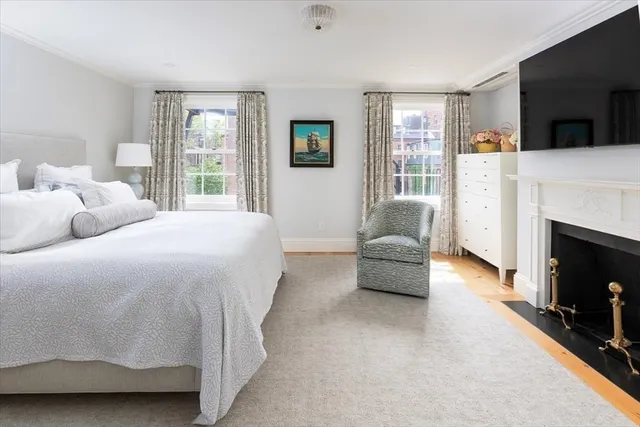 a spacious bedroom with a bed a couch and dresser