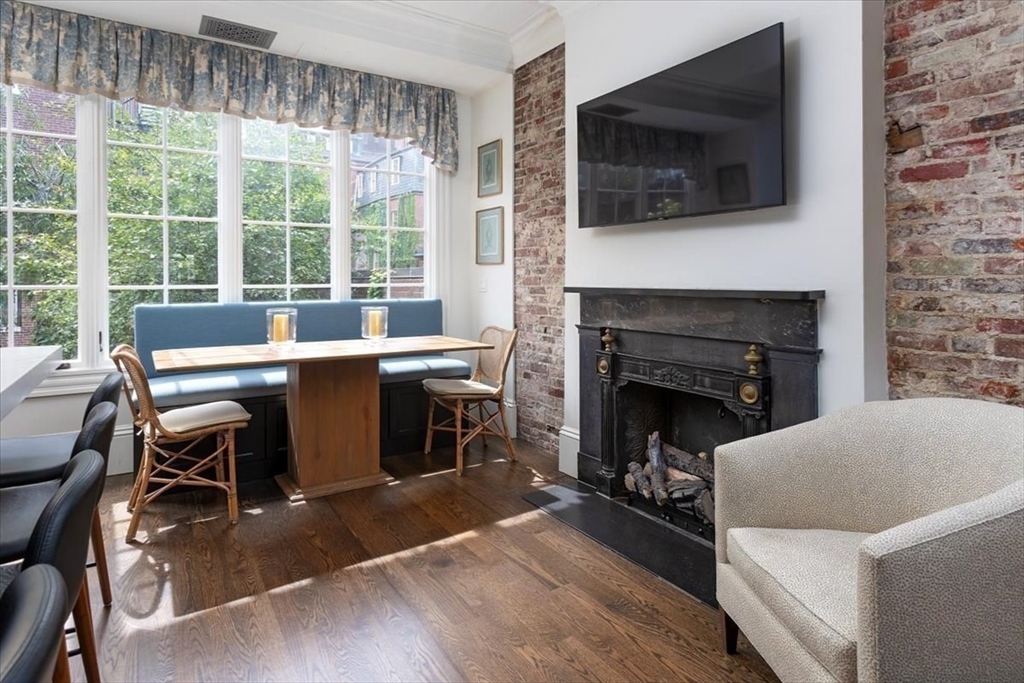 62 Chestnut Street Boston, MA 02108 - Photo 3 of 18 a living room with furniture a flat screen tv and a fireplace