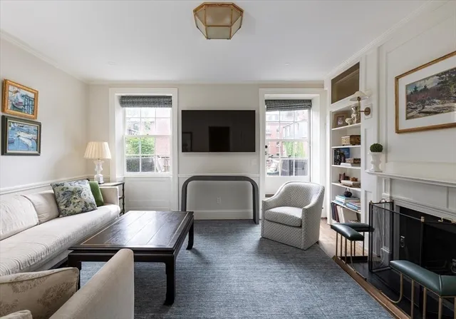 a living room with furniture a fireplace and a flat screen tv