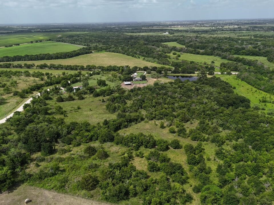 0 County Road 3255 Mount Calm, TX 76673 - Photo 11 of 12 an aerial view of a residential houses with outdoor space and trees