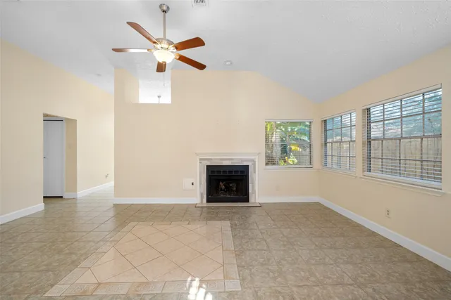 a living room with furniture chandelier and a fireplace