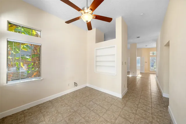 a dining room with furniture and a floor to ceiling window