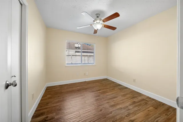 a bathroom with a granite countertop toilet a mirror and a sink