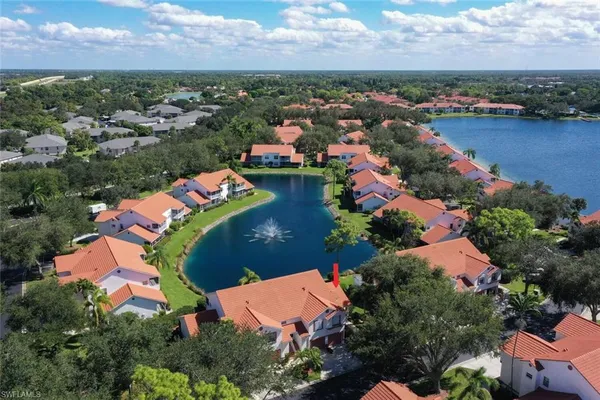 an aerial view of residential houses with outdoor space and lake view