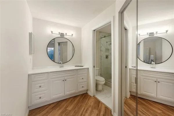 a bathroom with a toilet a sink and a mirror