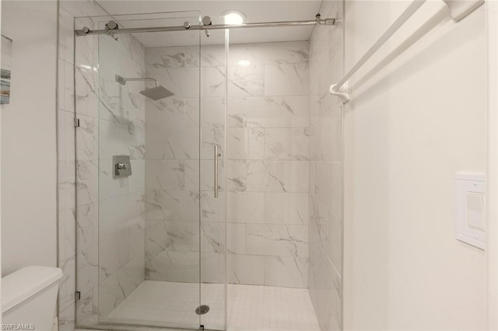 636 Windsor Square, Unit 102 Naples, FL 34104 - Photo 13 of 33 a bathroom with a shower