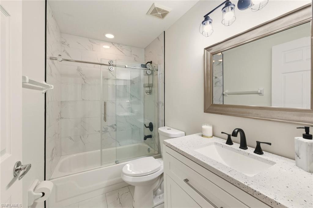 636 Windsor Square, Unit 102 Naples, FL 34104 - Photo 15 of 33 a bathroom with a sink a toilet and shower