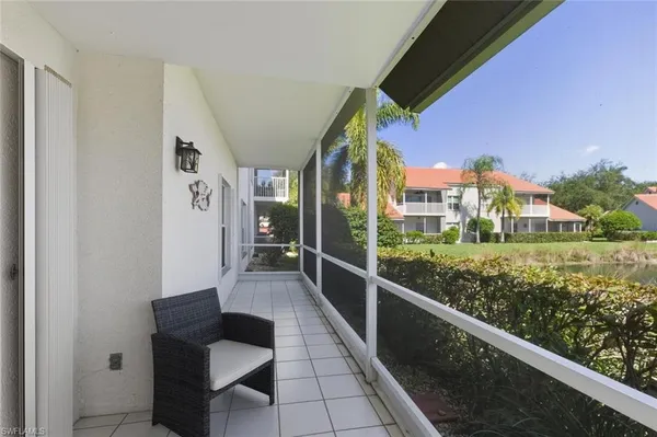 a view of a chair and tables in the balcony