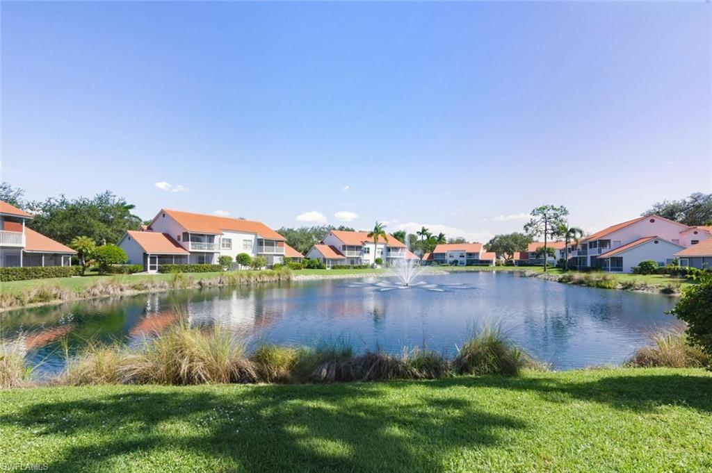 636 Windsor Square, Unit 102 Naples, FL 34104 - Photo 23 of 33 a view of a lake with a house in the background