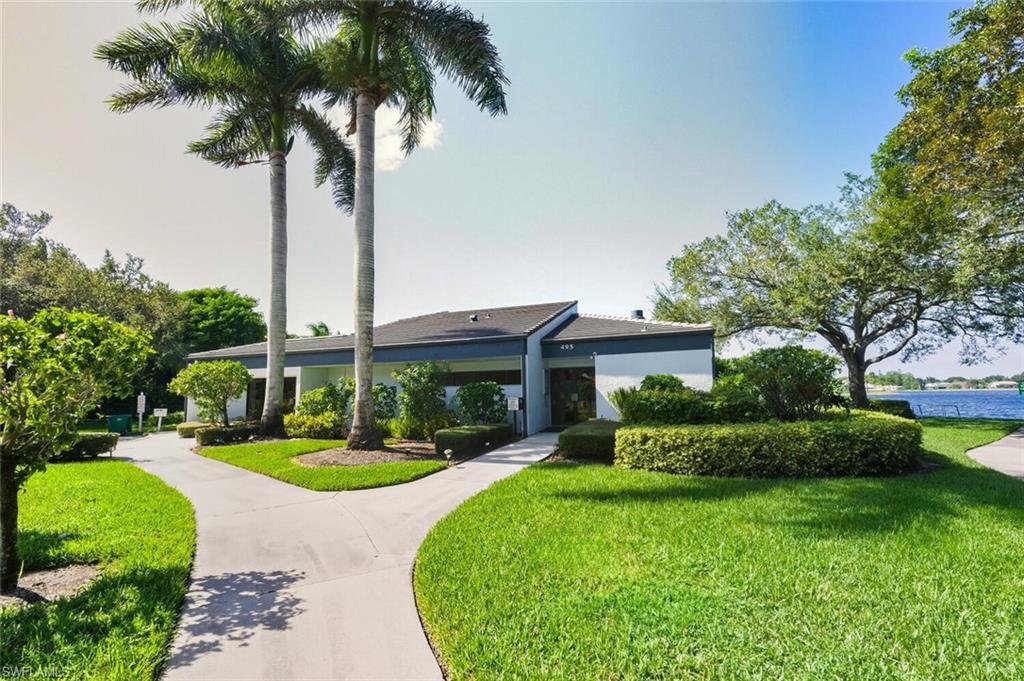 636 Windsor Square, Unit 102 Naples, FL 34104 - Photo 26 of 33 a front view of a house with yard and green space
