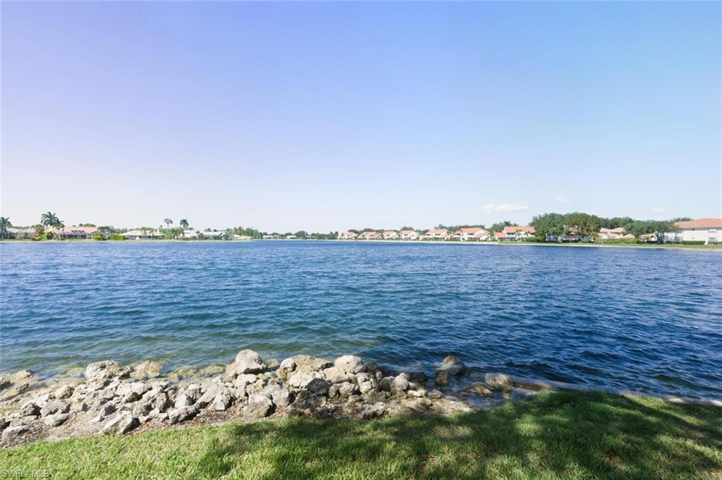636 Windsor Square, Unit 102 Naples, FL 34104 - Photo 32 of 33 a view of a lake with a city