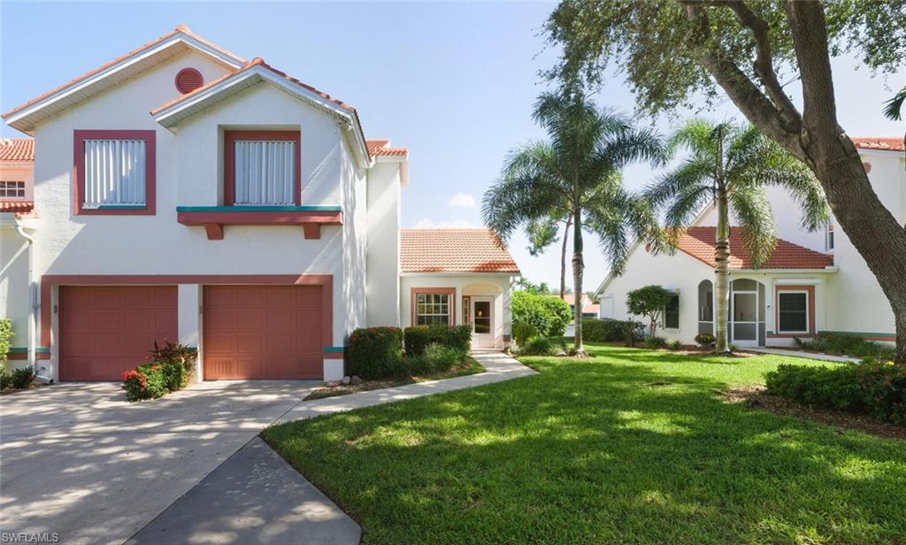 636 Windsor Square, Unit 102 Naples, FL 34104 - Photo 33 of 33 a front view of a house with a yard and garage