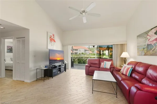 a living room with furniture a fireplace and a flat screen tv
