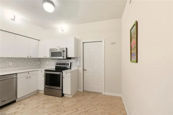 a kitchen with a sink and stainless steel appliances