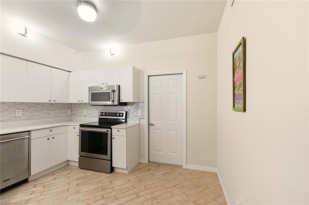636 Windsor Square, Unit 102 Naples, FL 34104 - Photo 8 of 33 a kitchen with a sink and stainless steel appliances