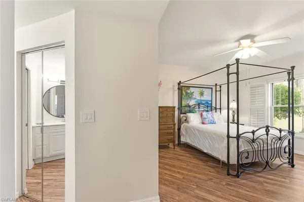 a bedroom with a bed and a mirror