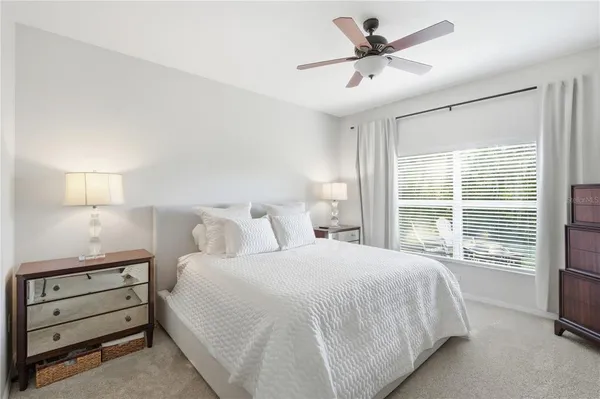 a bedroom with a bed and a large window