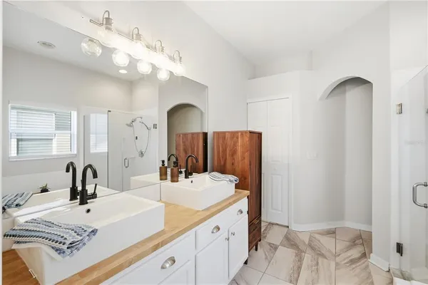 a spacious bathroom with a double vanity sink and a mirror