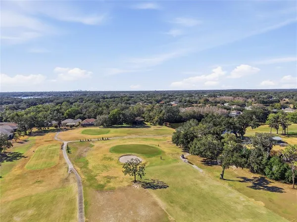 a view of a swimming pool and lake in back