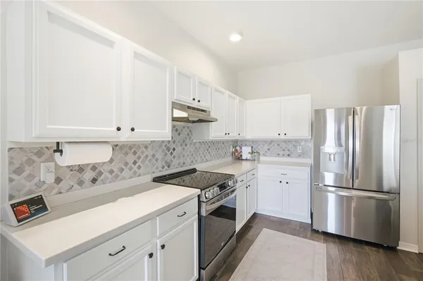 a kitchen with a white cabinets and white appliances
