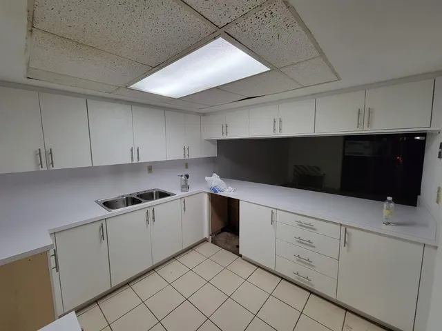 a kitchen with white cabinets