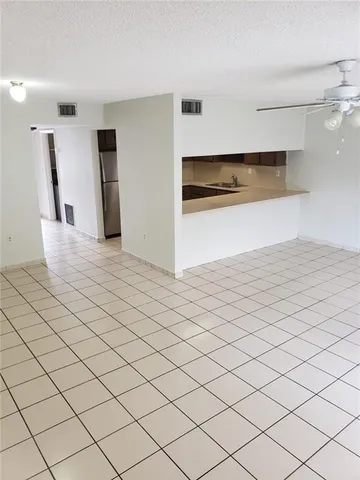 a view of a kitchen with natural light