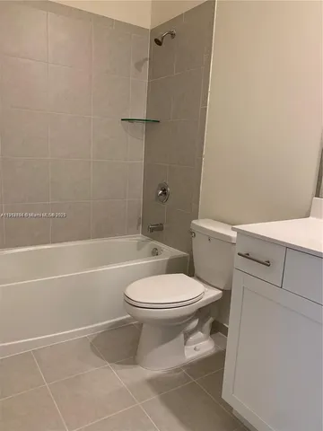 a bathroom with a toilet a sink and shower