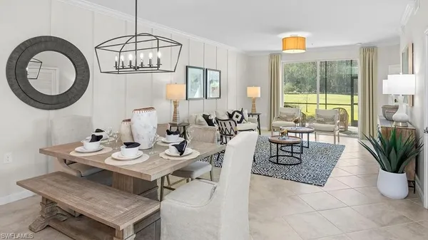 a living room with furniture a window and a chandelier
