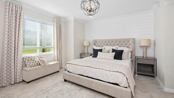 a bedroom with a bed and a chandelier