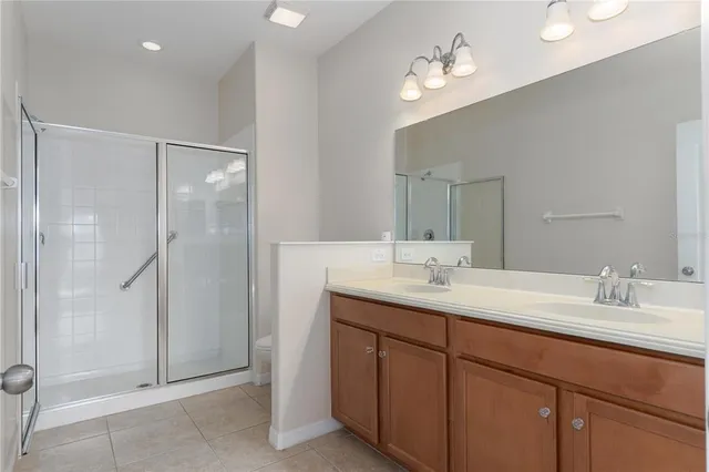 a bathroom with a double vanity sink and a mirror