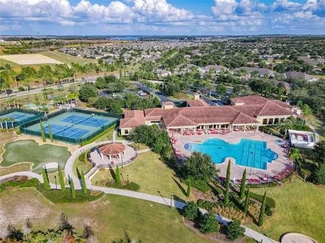 a patio table and chairs with potted plants and a fountain