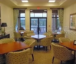 a room with pool table and windows