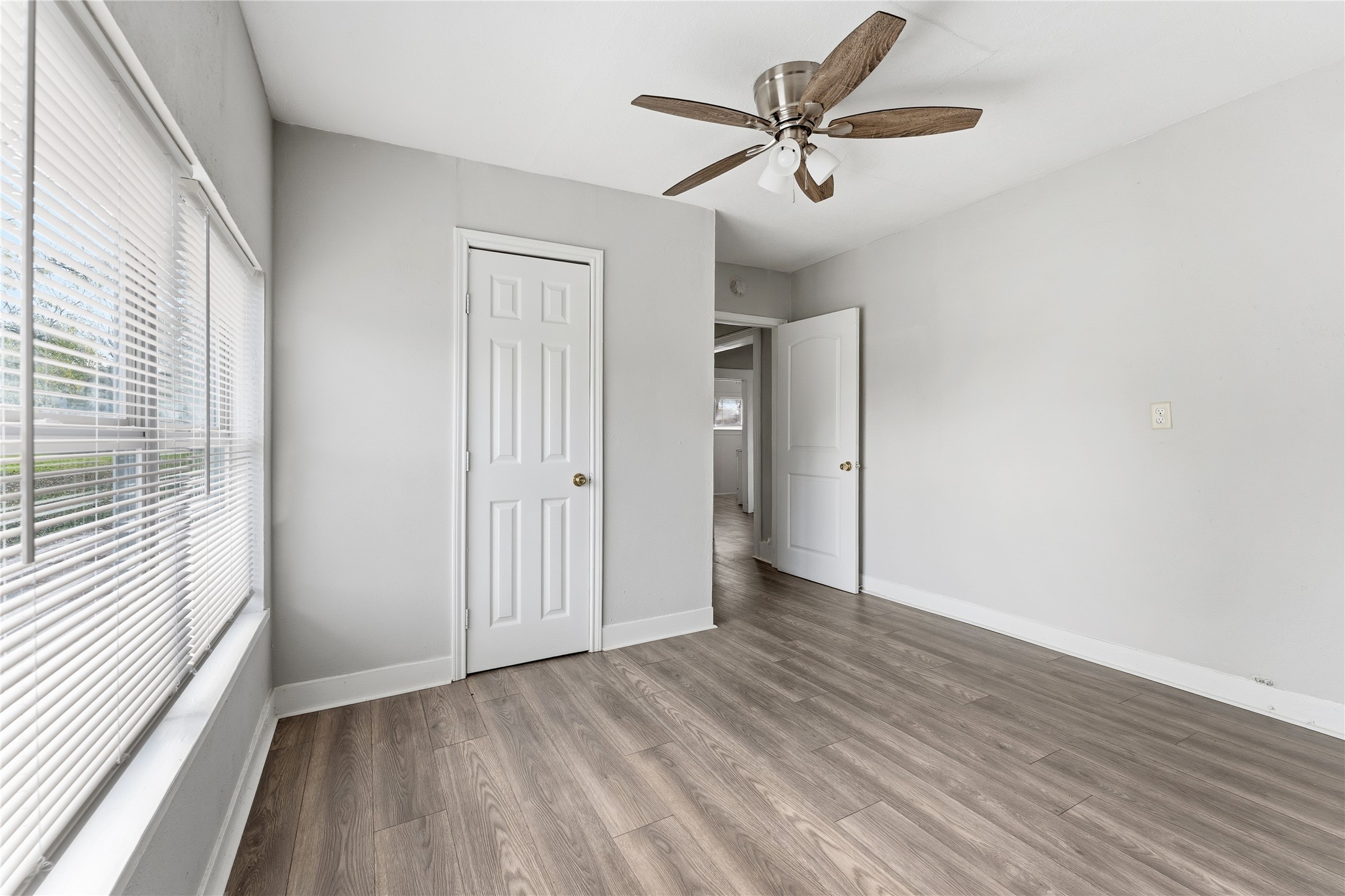 2105 Beaumont Road Baytown, TX 77520 - Photo 11 of 17 wooden floor in an empty room with a window