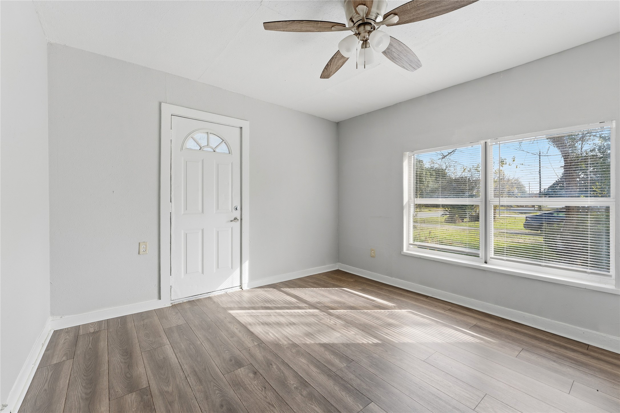 2105 Beaumont Road Baytown, TX 77520 - Photo 12 of 17 wooden floor in an empty room with a window