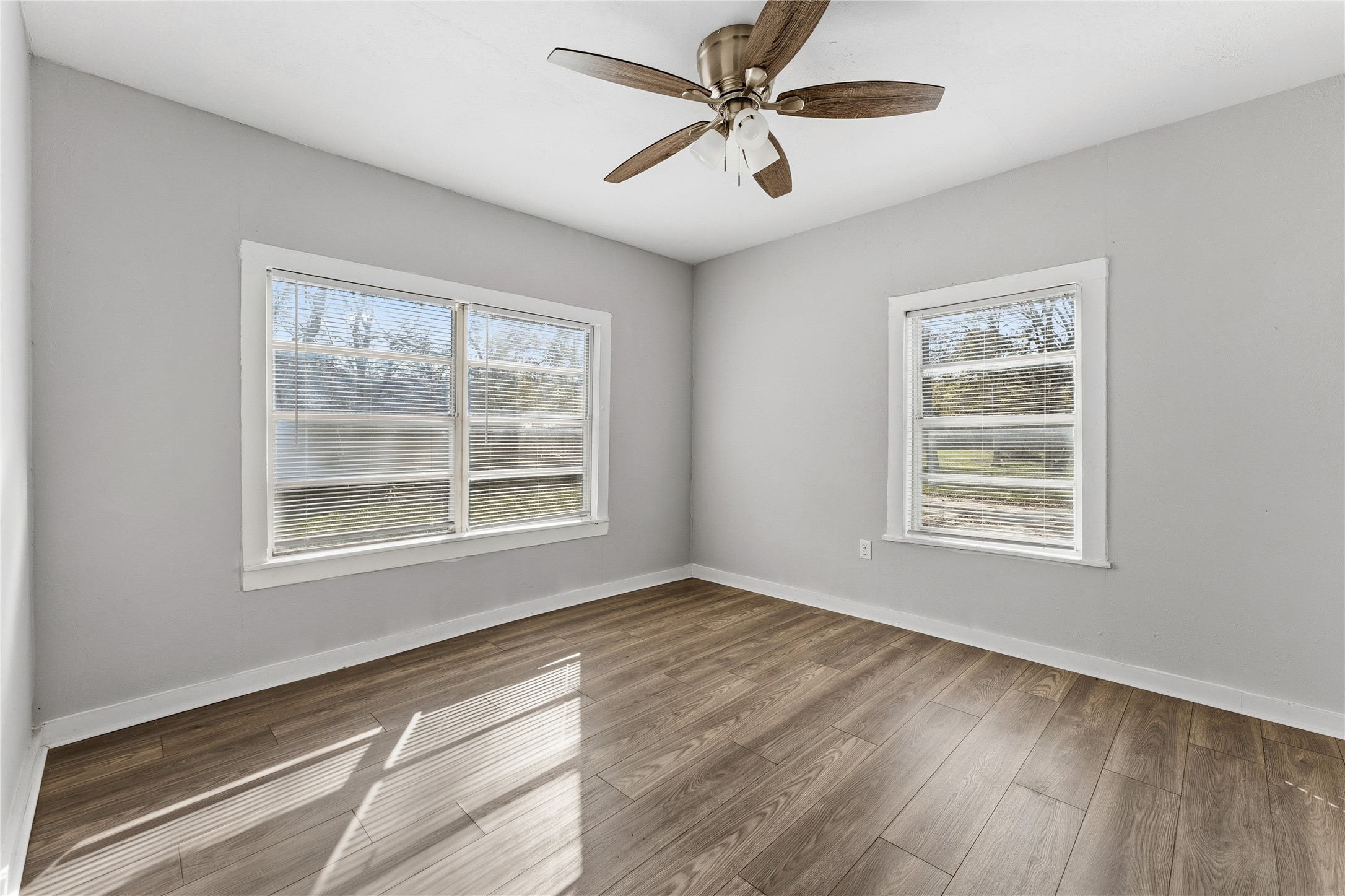2105 Beaumont Road Baytown, TX 77520 - Photo 13 of 17 a view of an empty room with wooden floor and a window