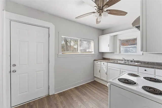 a kitchen with a stove a sink and a refrigerator