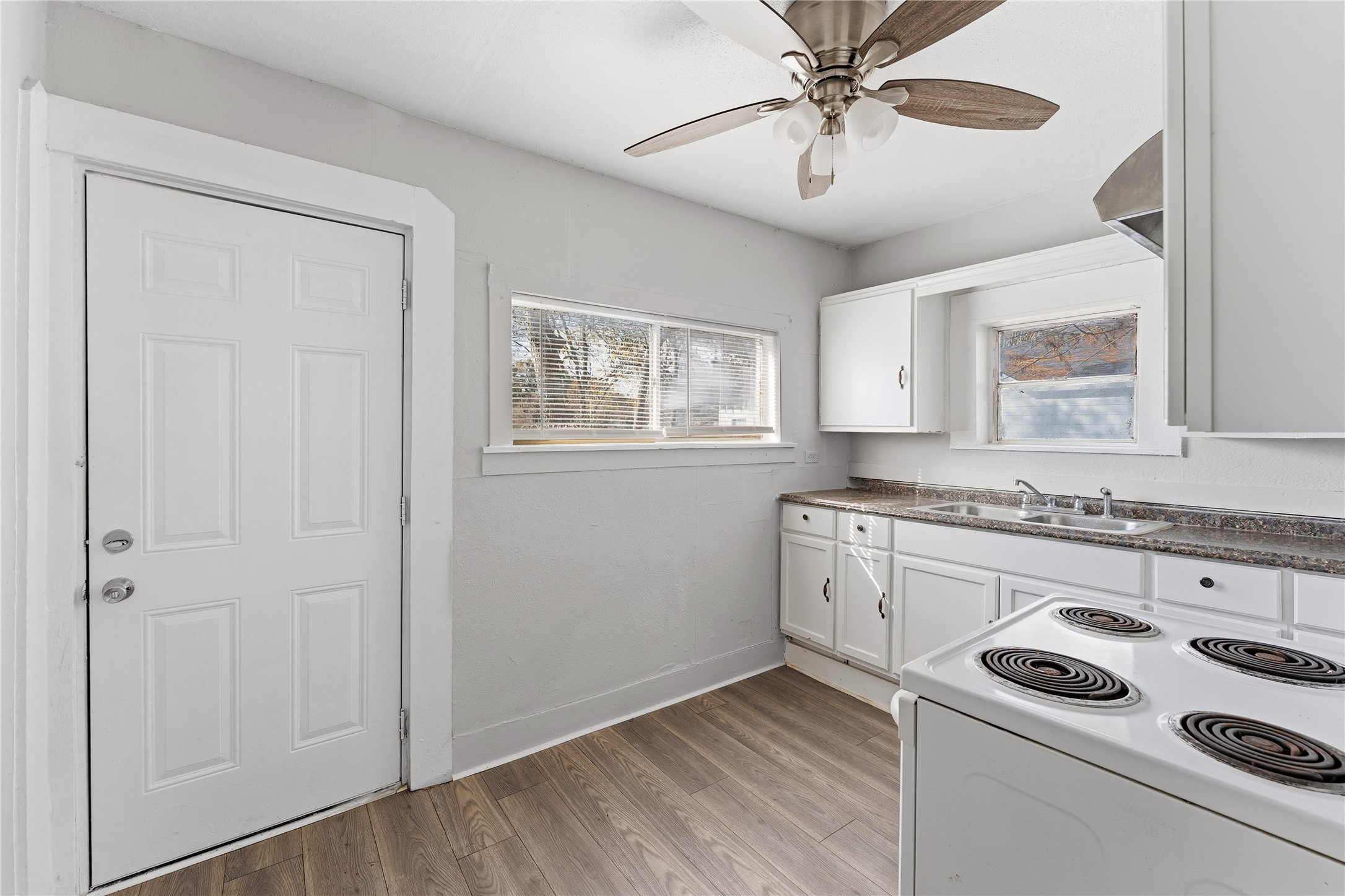 2105 Beaumont Road Baytown, TX 77520 - Photo 3 of 17 a kitchen with a stove a sink and a refrigerator