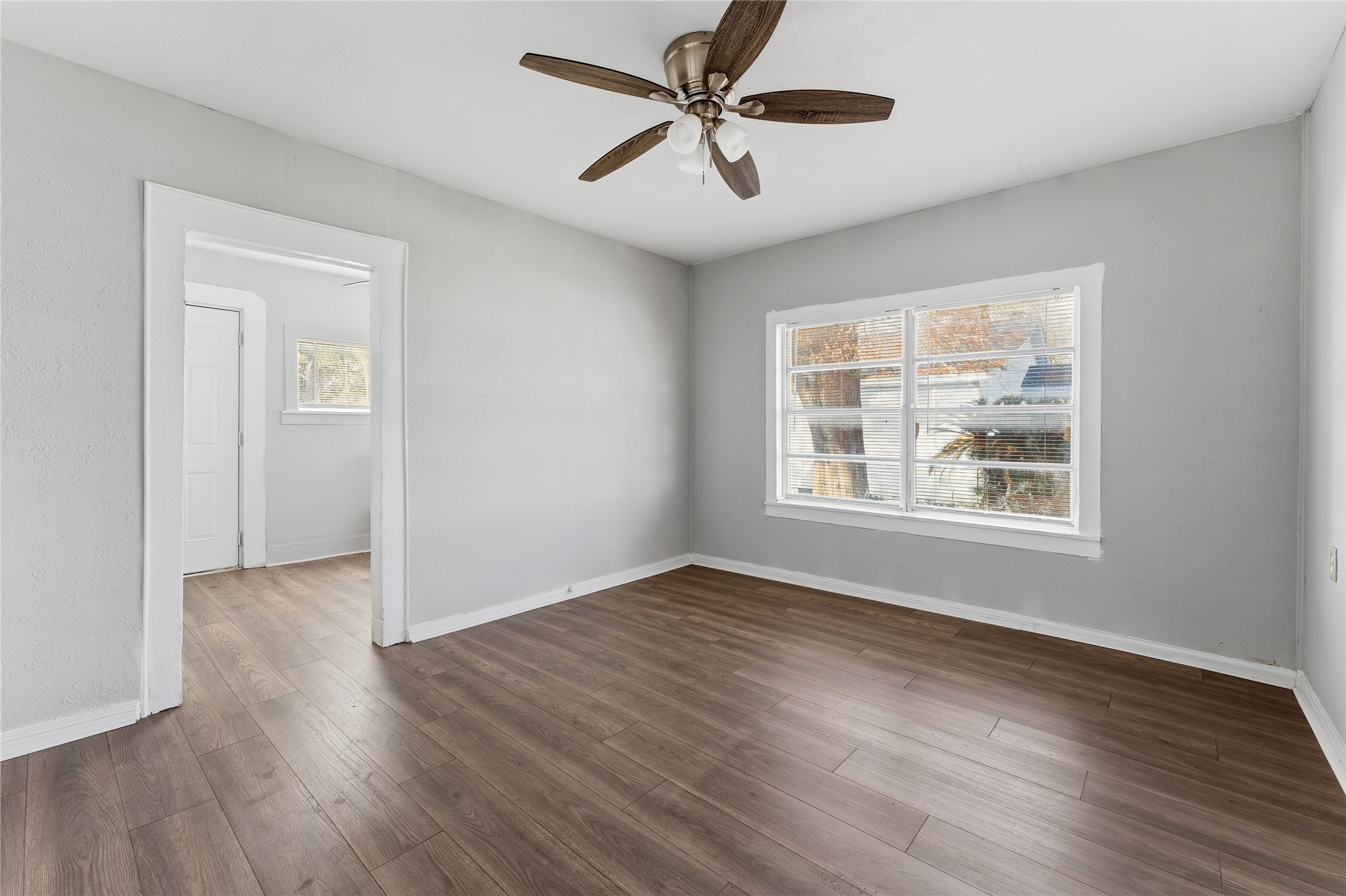 2105 Beaumont Road Baytown, TX 77520 - Photo 5 of 17 a view of an empty room with window and wooden floor