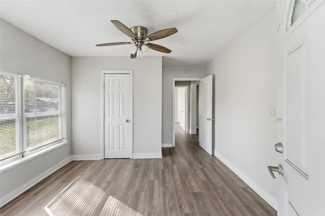 a view of a livingroom with a hardwood floor and a ceiling fan