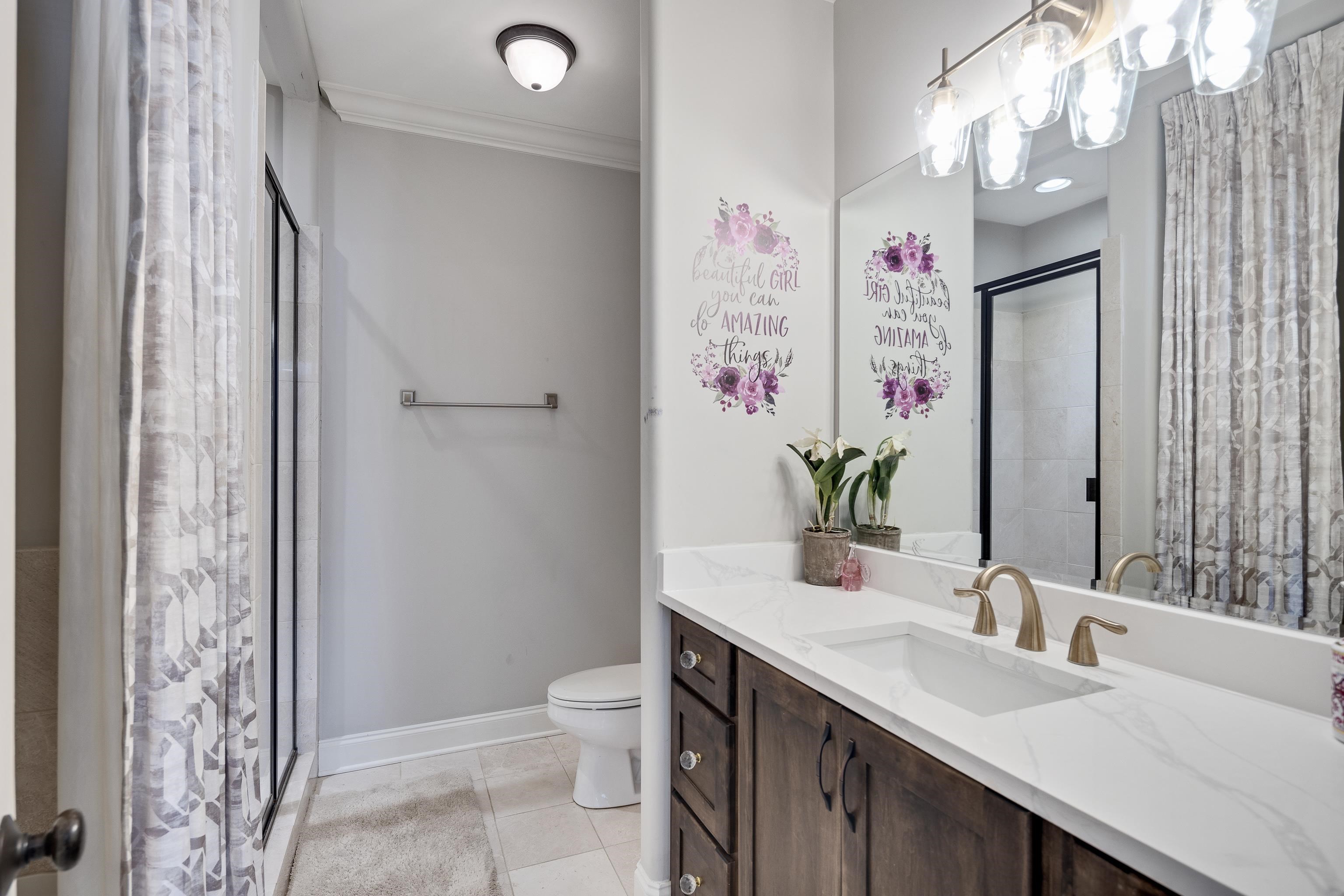 3246 Hollow Creek Road Germantown, TN 38138 - Photo 35 of 40 a bathroom with a granite countertop sink and a mirror