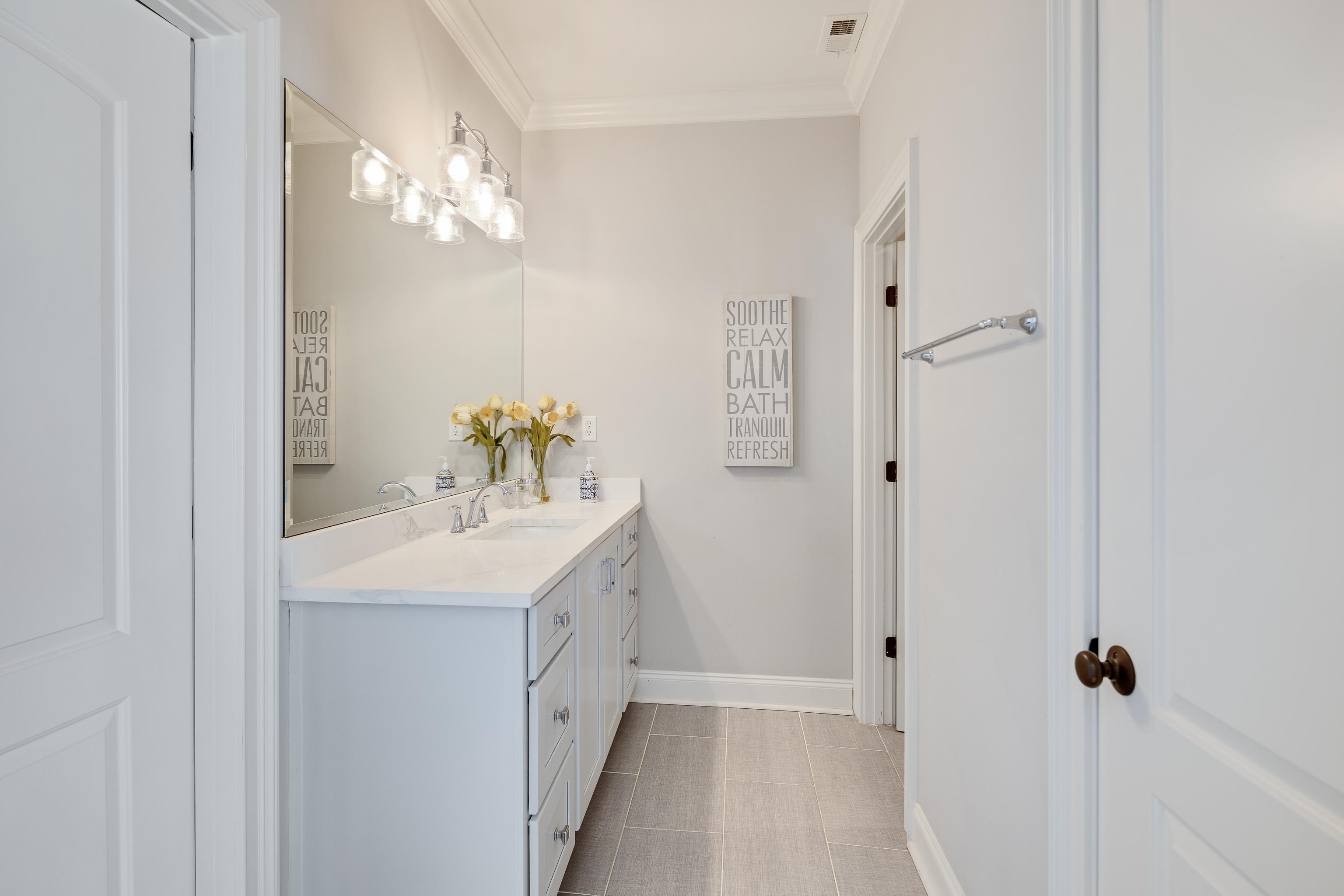 3246 Hollow Creek Road Germantown, TN 38138 - Photo 36 of 40 a bathroom with a sink a light fixture and a mirror