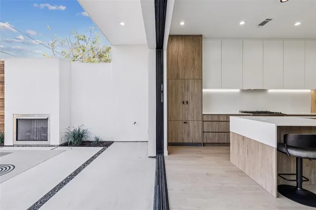 a spacious bathroom with a granite countertop sink a mirror and a shower