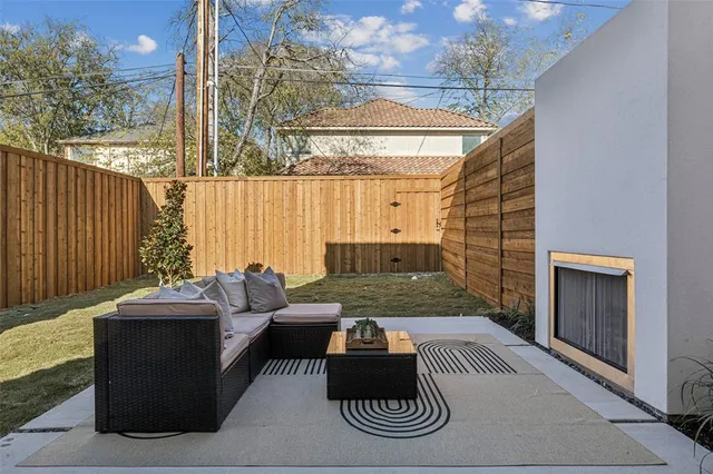 a outdoor living space with furniture and a fireplace