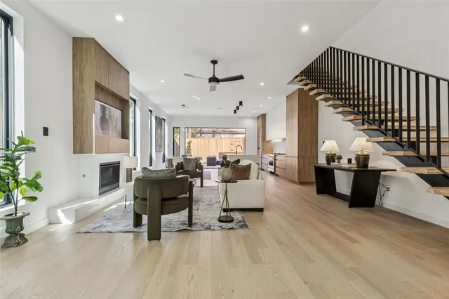 a living room with furniture or chandelier and a wooden floor