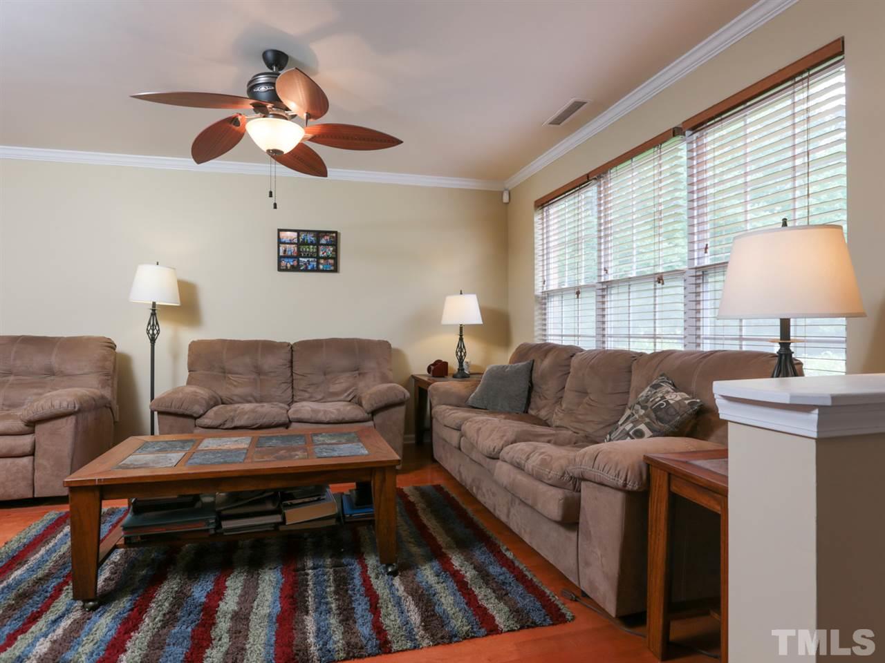 9908 Layla Avenue Raleigh, NC 27617 - Photo 3 of 25 a living room with furniture and a lamp